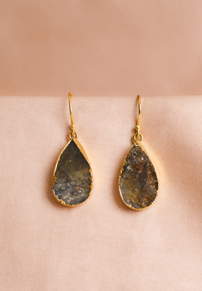 Chic teardrop-shaped metal drop earrings with a gold/moss green finish, showcasing a raw gemstone in an earthy gray and brown mix with a soft shimmer, and a curved hook closure