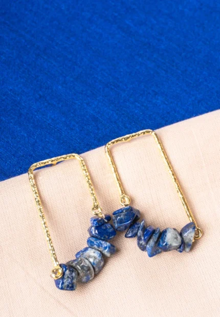 Elegant rectangular metal hoop earrings featuring a textured gold/navy blue finish and irregular marble-textured blue stones, completed with a push-back closure.