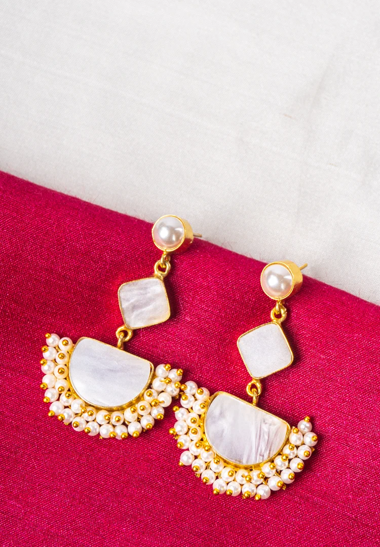 143-Th Statement geometric dangle earrings in a polished gold and pearl white finish, designed with a pearl top, an inverted square detail, a crescent-shaped base, and white enamel with pearl bead accents, completed with a push-back closure.