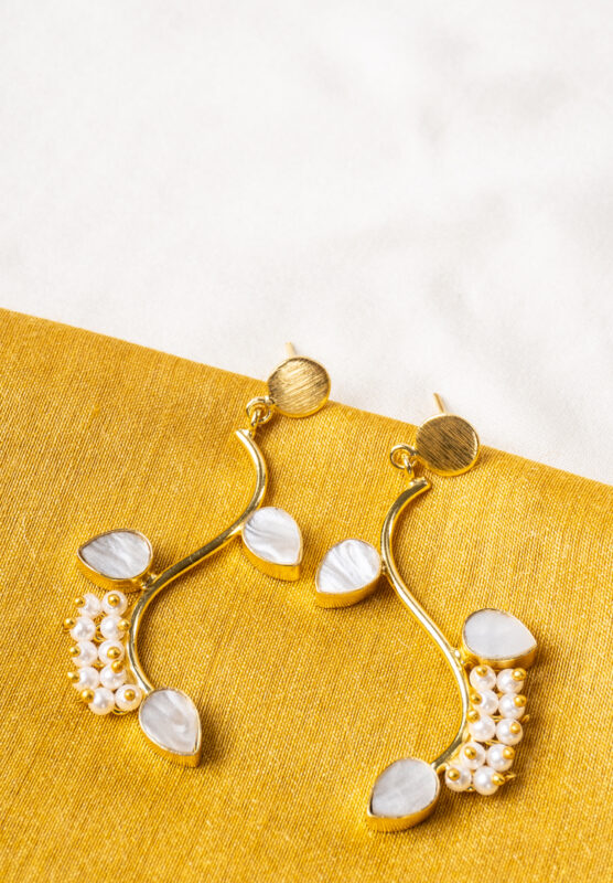 Elegant metal drop earrings in a polished gold, dark pink, and pearl white finish, showcasing overlapped oval links, a purple marble-textured stone, and delicate dangling pearls, finished with a push-back closure