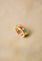 Trendy adjustable ring with a radiant gold-tone finish, eye-catching colorful gemstones, and intricate beaded accents.