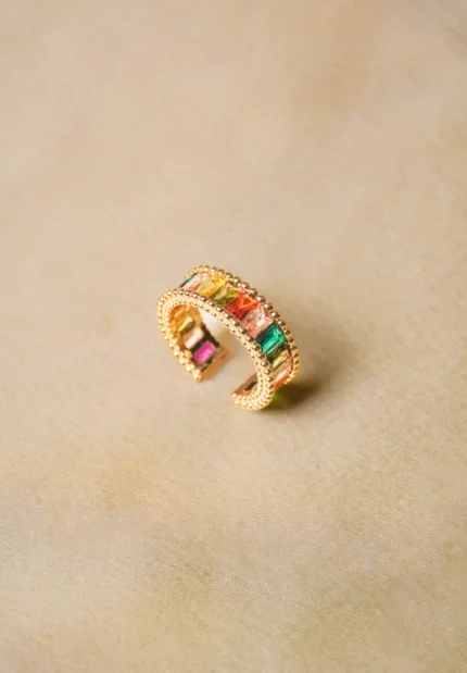 Trendy adjustable ring with a radiant gold-tone finish, eye-catching colorful gemstones, and intricate beaded accents.
