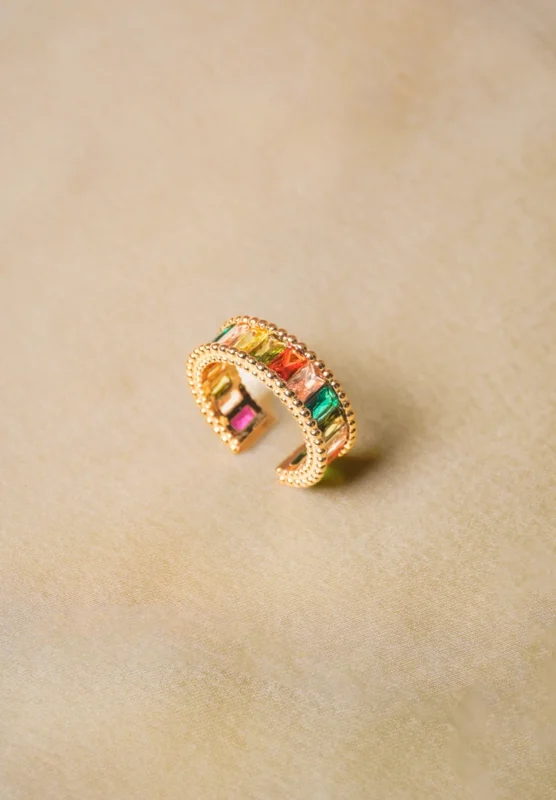 Trendy adjustable ring with a radiant gold-tone finish, eye-catching colorful gemstones, and intricate beaded accents.