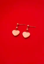 Romantic rose gold-toned earrings with a polished heart pendant, dainty bead details, and a comfortable push-back closure.
