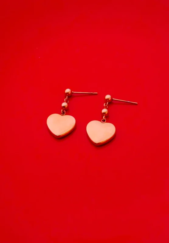 Romantic rose gold-toned earrings with a polished heart pendant, dainty bead details, and a comfortable push-back closure.