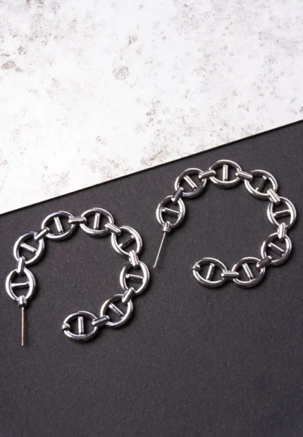 Trendy mini C-hoop earring with a polished silver-tone interlocking chain links and a small vintage-inspired coin charm, push-back post.