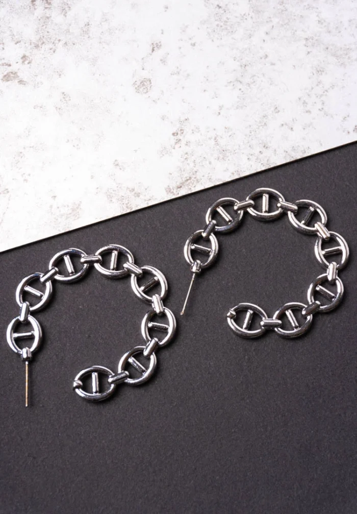 Trendy mini C-hoop earring with a polished silver-tone interlocking chain links and a small vintage-inspired coin charm, push-back post.