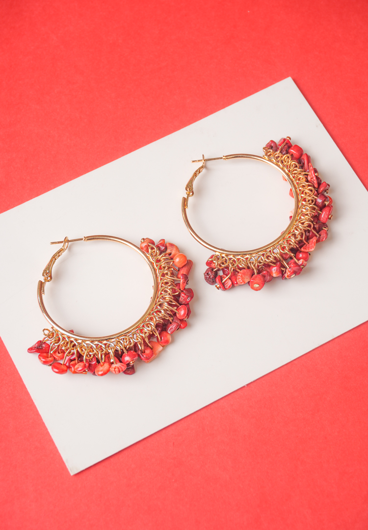190-Th Chic metal hoop earrings featuring a polished gold-tone finish, playful reddish orange stone beaded accents, and a hinged back for easy wear