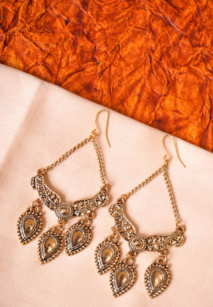 Stylish geometric metal dangle earrings with a silver finish along with colorful enamel detailing, delicate chain tassels with circular beads, and a push-back closure.