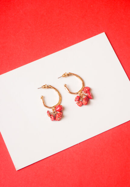 Trendy mini C-hoop earring with a polished silver-tone, golden tone/crimson red finish featuring dangling reddish stone chip beads at the bottom and , push-back post.