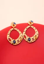 Unique gold-tone drop earrings featuring irregular hammered circular discs, shimmering clear and colorful gemstone embellishments, and a secure push-back closure