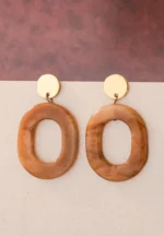 Chic oval resin drop earrings with a sleek geometric design, accented by a gold-tone top and finished with a push-back closure.