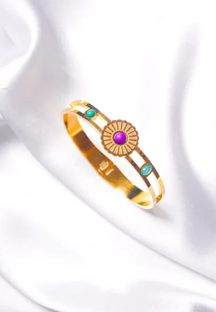Graceful hinged bracelet with a golden-tone finish, designed with a delicate flower design adorned with purple, green, and teal blue gemstones