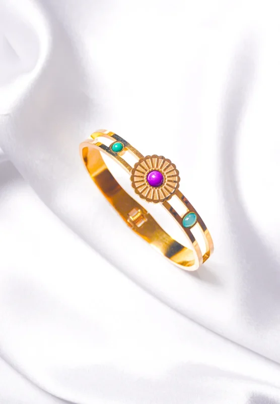 Graceful hinged bracelet with a golden-tone finish, designed with a delicate flower design adorned with purple, green, and teal blue gemstones
