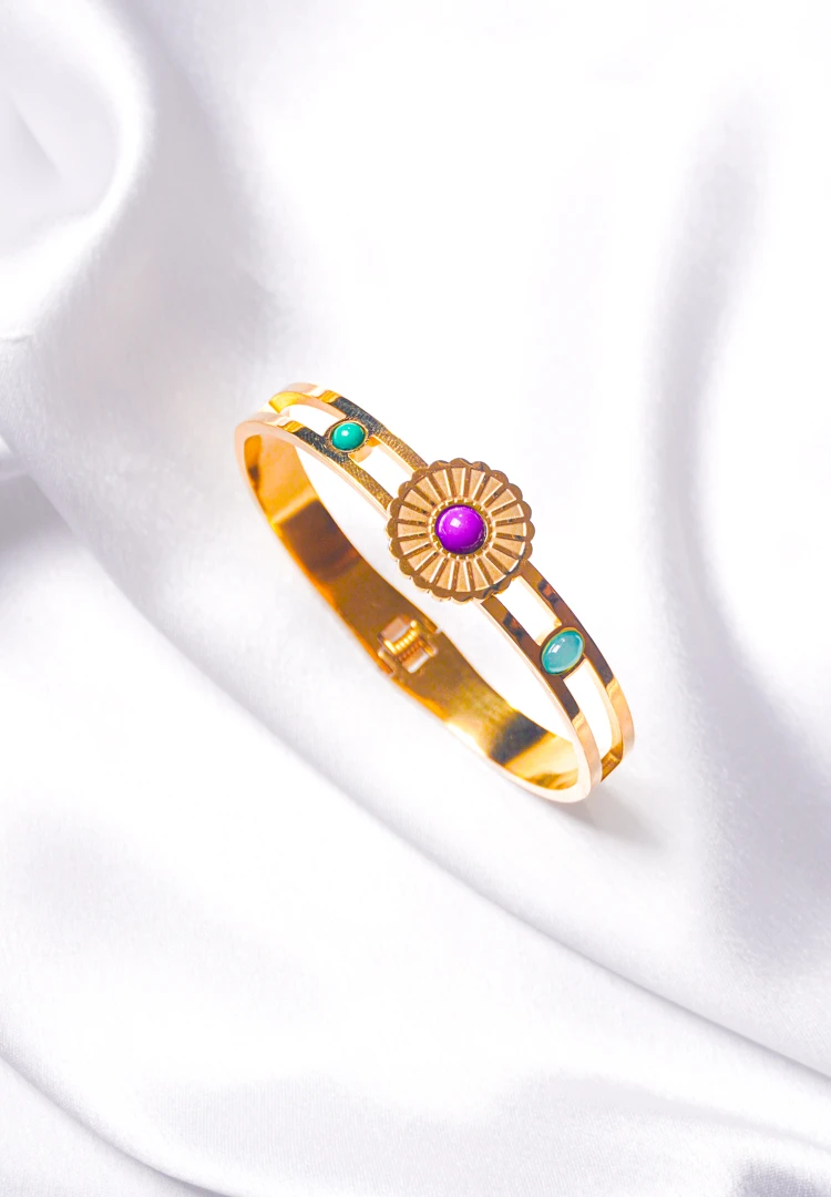 217-Th Graceful hinged bracelet with a golden-tone finish, designed with a delicate flower design adorned with purple, green, and teal blue gemstones