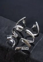 Sleek and contemporary dangle earrings with a coiled spiral structure, finished in a silver tone and secured with a push-back post.