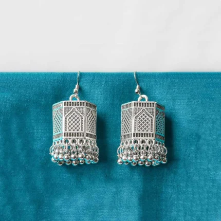 Stylish geometric metal dangle earrings with a silver finish along with colorful a hexagonal shaped jhumka, ghungroo at the end, and a push-back closure.