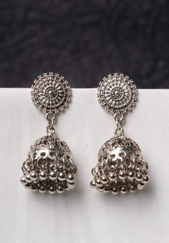 Traditional oxidized silver jhumka earring featuring fine intricate detailing, a floral-designed top, and a secure push-back closure