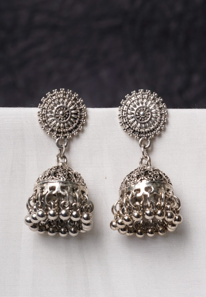 Traditional oxidized silver jhumka earring featuring fine intricate detailing, a floral-designed top, and a secure push-back closure