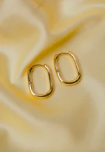 Refined gold-tone elongated oval metal hoop earrings and a push back closure