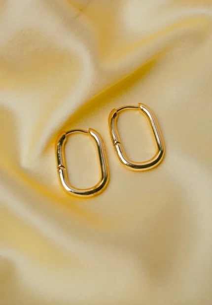 Refined gold-tone elongated oval metal hoop earrings and a push back closure