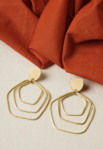 Contemporary brass earring with an intricate geometric design of three overlapping hexagon-shaped spheres, a crescent accent on top, and a push-back closure for comfort