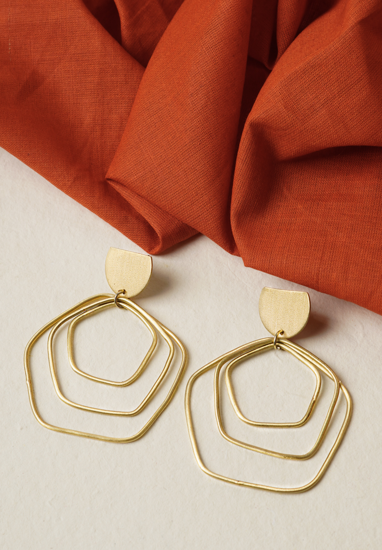 279-Th Contemporary brass earring with an intricate geometric design of three overlapping hexagon-shaped spheres, a crescent accent on top, and a push-back closure for comfort