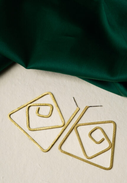 Minimalist brass earrings with an irregular abstract design, subtle texture detailing, and a classic push-back closure