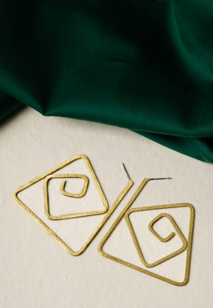 Minimalist brass earrings with an irregular abstract design, subtle texture detailing, and a classic push-back closure