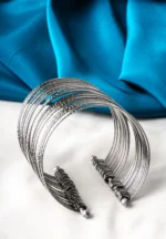 Oxidized silver-tone metal cuff bracelet featuring fine intricate detailing