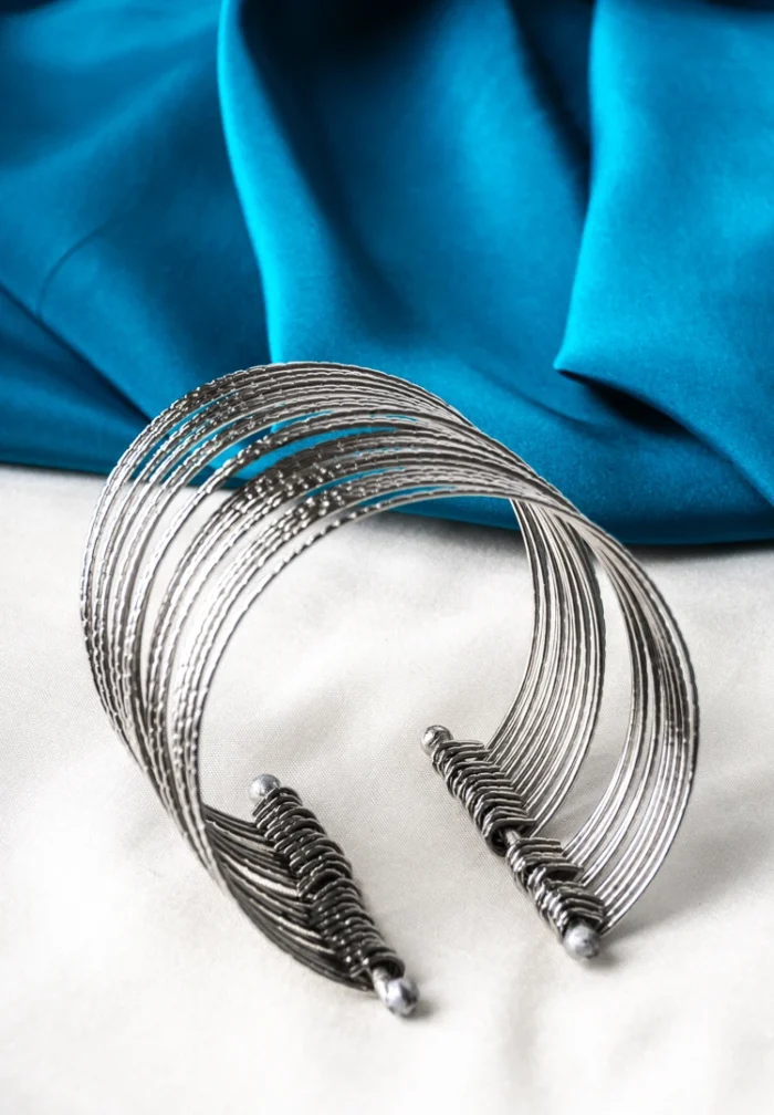 Oxidized silver-tone metal cuff bracelet featuring fine intricate detailing