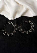 Delicately designed oxidized silver C hoop earring adorned with dangling ghungroos and finished with a push-back closure