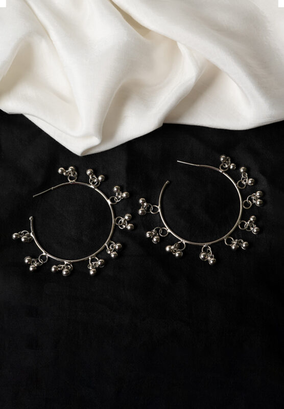 Delicately designed oxidized silver C hoop earring adorned with dangling ghungroos and finished with a push-back closure