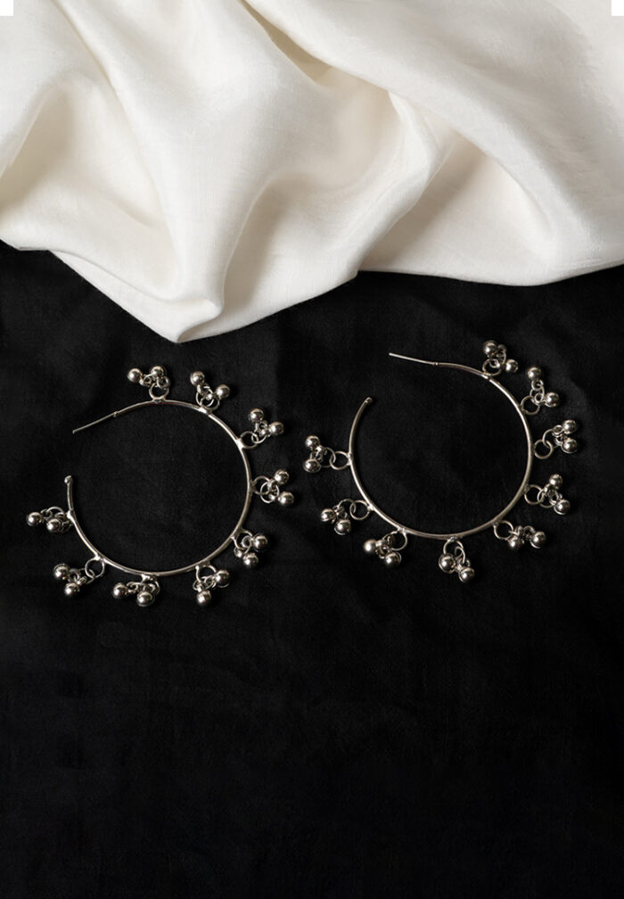 Delicately designed oxidized silver C hoop earring adorned with dangling ghungroos and finished with a push-back closure