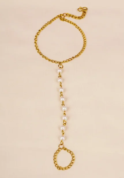 Dainty curb chain bracelet in a gold-tone finish, accented with tiny dangling rectangular gemstones in various colors and a lobster claw clasp