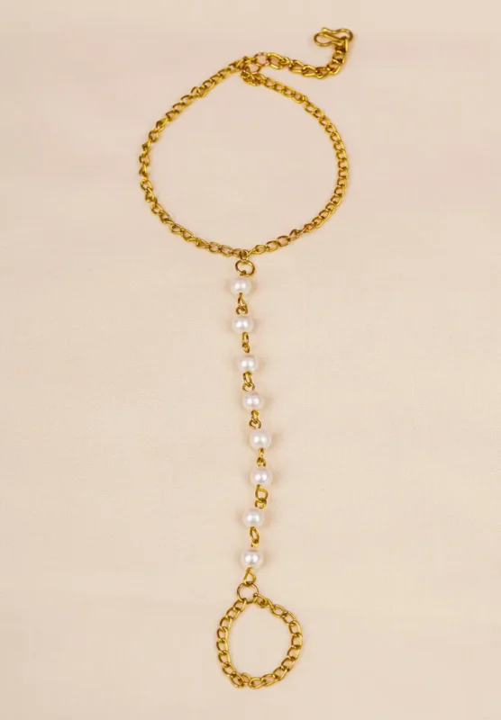 Dainty curb chain bracelet in a gold-tone finish, accented with tiny dangling rectangular gemstones in various colors and a lobster claw clasp