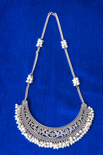 Traditional oxidized silver-tone curb chain necklace featuring a semi-circle shaped pendant with fine detailing, pearl clusters, and a delicate row of pearls along the edge, finished with an S-hook clasp