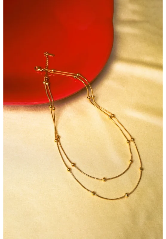 Timeless multi-strand snake chain necklace in gold/silver, embellished with delicate symmetrical beads and a durable lobster clasp.