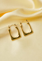 Timeless and sophisticated open-end rectangular metal hoop earrings with a high-shine gold-tone finish and a classic hinged back closure