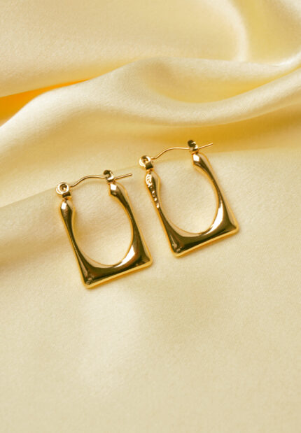 Timeless and sophisticated open-end rectangular metal hoop earrings with a high-shine gold-tone finish and a classic hinged back closure