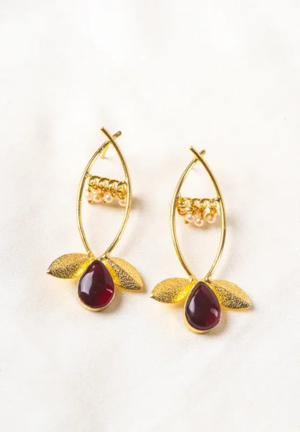 Charming oxidized silver-tone floral dangling earring with delicate detailing, red-colored teadrop shaped stones, two- textured leaves at the bottom, and a push-back post for a secure fit.