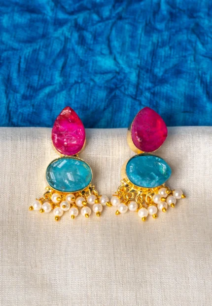 Chic teardrop-shaped metal drop earrings with a gold/aqua blue finish, showcasing a raw gemstone in an blue colored oval shaped druzy with series of a small pearl beads, and a push back closure.