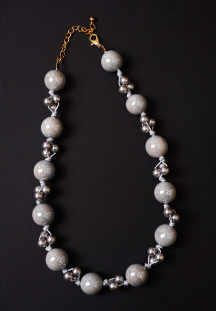 Elegant beaded necklace with a gold-tone/grey finish, featuring round grey beads and a secure lobster claw clasp