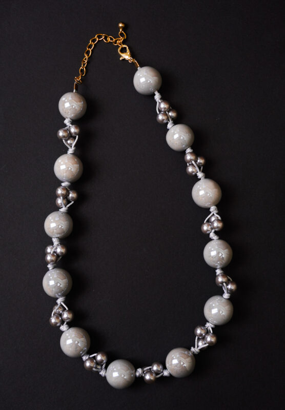 Elegant beaded necklace with a gold-tone/grey finish, featuring round grey beads and a secure lobster claw clasp