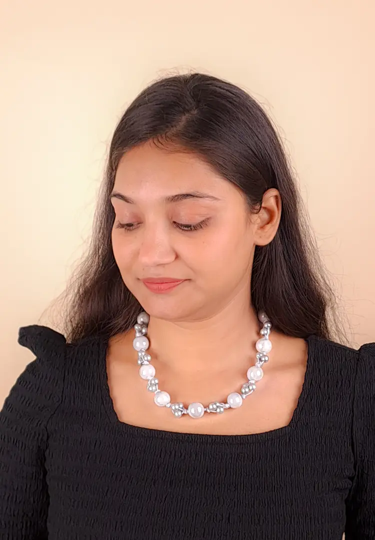 509 edited Elegant beaded necklace with a gold-tone/grey finish, featuring round grey beads and a secure lobster claw clasp