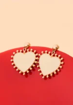 Elegant dangling earrings featuring enamel detailing framed with small beads and a push back closure.