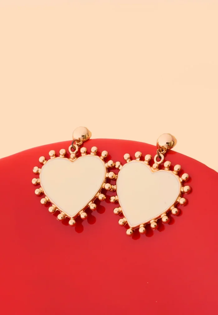 Elegant dangling earrings featuring enamel detailing framed with small beads and a push back closure.