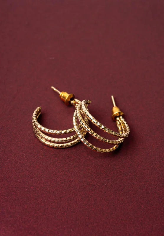 Stylish three-tier c hoop earrings with a golden/silver-tone finish, pink bead accents, and a push back closure.
