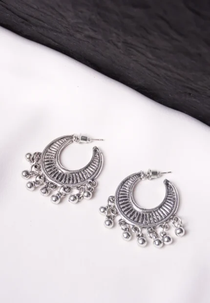 Elegant gold-tone semi-circular hoop earrings with a curved design, textured finish, dangling circular bead accents, and a push-back closure.