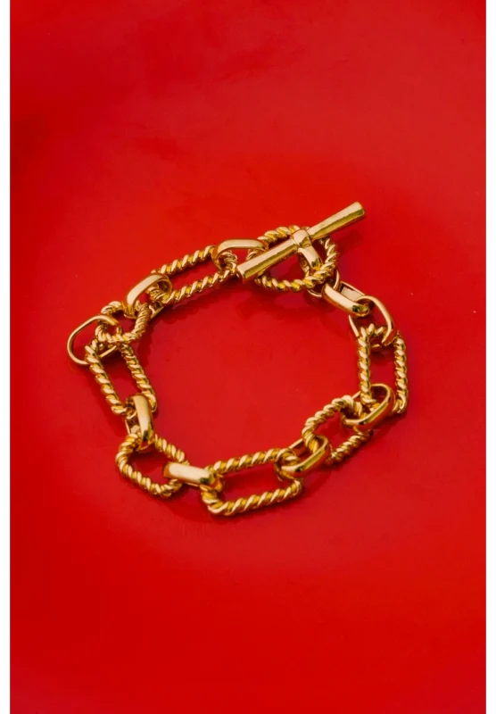 Sleek twisted spiral gold-tone bracelet crafted from metal gauge wire, finished with a classic toggle clasp